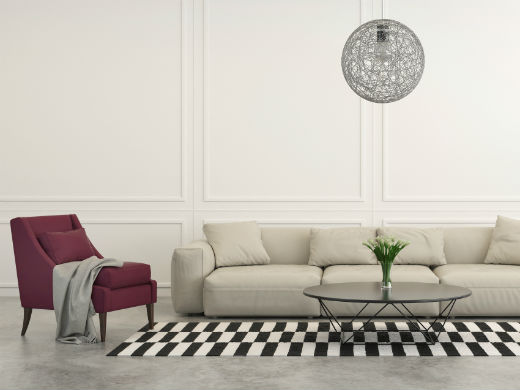 Minimalist high net worth home with white sofa and maroon chair